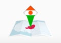 Niger is depicted on a folded paper map and pinned location marker with flag of Niger