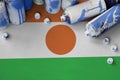 Niger flag and few used aerosol spray cans for graffiti painting. Street art culture concept