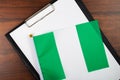 Nigeria document, mockup for text on clipboard, white sheet of paper in a folder for notes with Nigeria flag Royalty Free Stock Photo