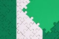 Nigeria flag is depicted on a completed jigsaw puzzle with free green copy space on the right side