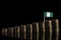 Nigerian flag with lot of coins on black