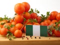 Nigerian flag on a wooden panel with tomatoes isolated on a whit