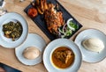 Nigerian Food: Delicious Pounded Yam, Eba, Banga Soup and Efo riro with roasted fish for Lunch Royalty Free Stock Photo