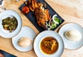 Nigerian Food: Delicious Pounded Yam, Eba, Banga Soup and Efo riro with roasted fish for Lunch Royalty Free Stock Photo