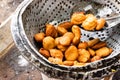 Nigerian Street food: Delicious Akara Fried Bean Cake for sale on metal seive Royalty Free Stock Photo