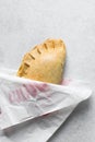 Nigerian meat pie on a marble tray, freshly baked nigerian meat pie