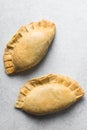 Nigerian meat pie on a marble tray, freshly baked nigerian meat pie