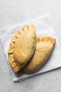 Nigerian meat pie on a marble tray, freshly baked nigerian meat pie