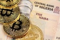 Nigerian 5 Naira bank notes with gold bitcoins