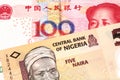 A Nigerian naira bill with with a Chinese yuan bank note close up