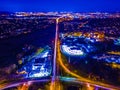 Night aerial shot of a city with lights and traffic