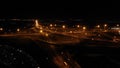 Night Aerial view of highway cloverleaf interchange intersection with ramps, heavy traffic, aerial. Road interchange