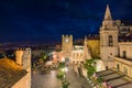 Night aerial view of Square Piazza IX Aprile with San Giuseppe church and Clock Tower in Taormina, Sicily, Italy