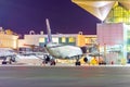 Night airport apron, modern passenger airliner at the jet bridge Royalty Free Stock Photo