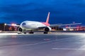 Night airport view and a large passenger plane in the parking lot before the flight Royalty Free Stock Photo