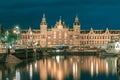 Night Amsterdam canal and Centraal Station Royalty Free Stock Photo