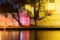 Night architecture in city. Church on the bank of river.