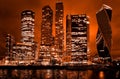 Night architecture - skyscrapers with glass facade. Modern buildings in red tone