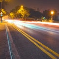 Night asphalt road in the city with car light trails