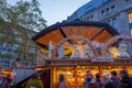 Night atmosphere with crowd of people and illuminated decorated stalls at Christmas Market.