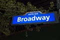 Night backlit street sign corner sixth ave broadway blue white s Royalty Free Stock Photo
