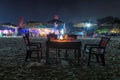 Night beach party in cafe with bottle of rose wine and glasses in GOA, India Royalty Free Stock Photo