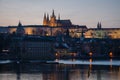 The night begin to fall over the city and the city lights reflect over the Moldava river, Prague, Czech Republic