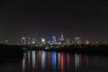 Night in big city of Warsaw skyline, high skyscrapers illumination reflected on Wisla river surface. Downtown beautiful Royalty Free Stock Photo