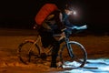 Night bike rider check map in the light of headlight