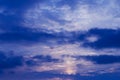 Night blue sky and moonlight background. The magic moon shines in the night sky through dark blue clouds Royalty Free Stock Photo