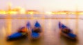 Night blurred view on the moored gondolas on the pier near the Piazza San Marco in Venice Royalty Free Stock Photo