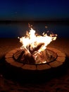 Night bonfire on the beach at Chippewa Lake, Michigan. Royalty Free Stock Photo