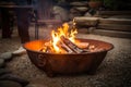 Night bonfire in metal bowl stand flaming sparks and garlands background.