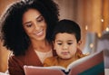 Night, book and mother with child reading for bedtime storytelling, fairytale and education. Relax, happiness and smile Royalty Free Stock Photo