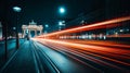 At night, the Brandenburg Gate is illuminated by a motion-blurred light trail in a long exposure shot. Royalty Free Stock Photo