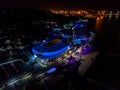 Night bright hotel with dolphin shaped pool