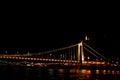 Night Budapest, glowing in gold. The bridge over the Danube is illuminated by light bulbs. photo from the river