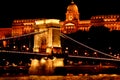 Night Budapest, glowing in gold. The chain bridge over the Danube is illuminated by light bulbs. photo from the river Royalty Free Stock Photo