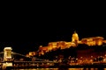 Night Budapest, glowing in gold. The chain bridge over the Danube is illuminated by light bulbs. photo from the river Royalty Free Stock Photo