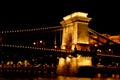 Night Budapest, glowing in gold. The chain bridge over the Danube is illuminated by light bulbs. photo from the river Royalty Free Stock Photo