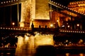 Night Budapest, glowing in gold. The chain bridge over the Danube is illuminated by light bulbs. photo from the river Royalty Free Stock Photo