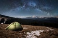 Night camping. Illuminated tourist tent under beautiful night sky full of stars and milky way Royalty Free Stock Photo