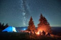 Night camping in mountains under starry sky with Milky way.