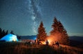 Night camping in mountains under starry sky with Milky way. Royalty Free Stock Photo