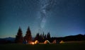 Night camping in mountains under starry sky with Milky way.