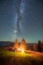 Night camping in mountains under starry sky with Milky way.