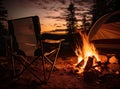 Night camping near bright fire in spruce forest under starry magical sky. Tourism, camping concept. Royalty Free Stock Photo