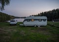 Night campsite camping caravan by lake Ragnerudssjoen in Dalsland Sweden beautiful nature forest pinetree Royalty Free Stock Photo