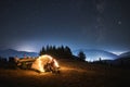 Night campsite in the mountains lawn under starry sky. Royalty Free Stock Photo