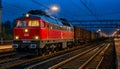 Night Cargo: Powerful locomotive hauling freight at twilight Royalty Free Stock Photo